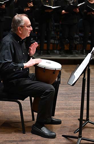 This is a picture of percussionist, Jeff Loewer, performing "Sing My Child" with the combined choirs, ( The NOVA Community Chorus, The Arlington Community Chorus & Brentsville District High School Choirs), at the Rachel M. Schlesinger Concert Hall and Arts Center on March 1, 2024. 
