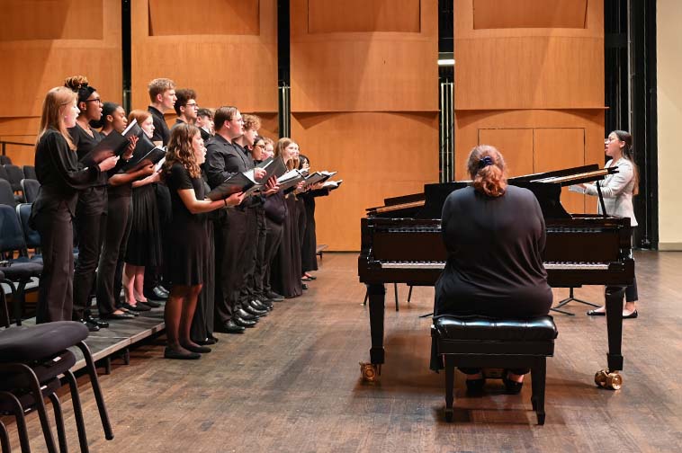 This is a photo of (L-R) Members of the Brentsville District High School Choir Collaborative Pianist Rachel Bradley and Director Anna Balchunas with performing at the Chorus Spring concert at the Rachel M. Schlesinger Concert Hall and Arts Center on the March 1st, 2024.