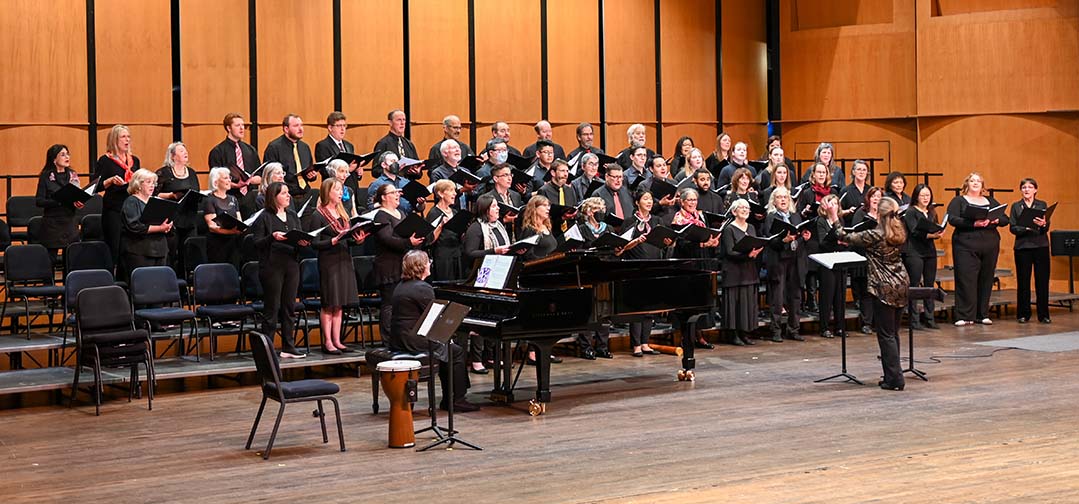 This is a photo of The Arlington Community Chorus directed by Cynthia Young, accompanied by collaborative pianist Diane Carsten-Pelak, performing at the Chorus Spring concert at the Rachel M. Schlesinger Concert Hall and Arts Center on the March 1st, 2024.
