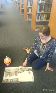 Librarian shows Caterprie, a buglike pokemon, a book