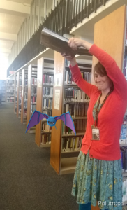 A library staff member tries to smash a zubat, a batlike pokemon.