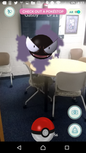 Gastly, a ghost pokemon, floats in a group study room.