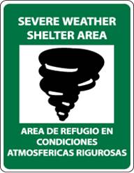 Shelter sign. Green background with white text: Severe Weather Shelter Area, an illustration of a tornado and, in Spanish, Area de refugio en condiciones atmosfericas rigurosas.