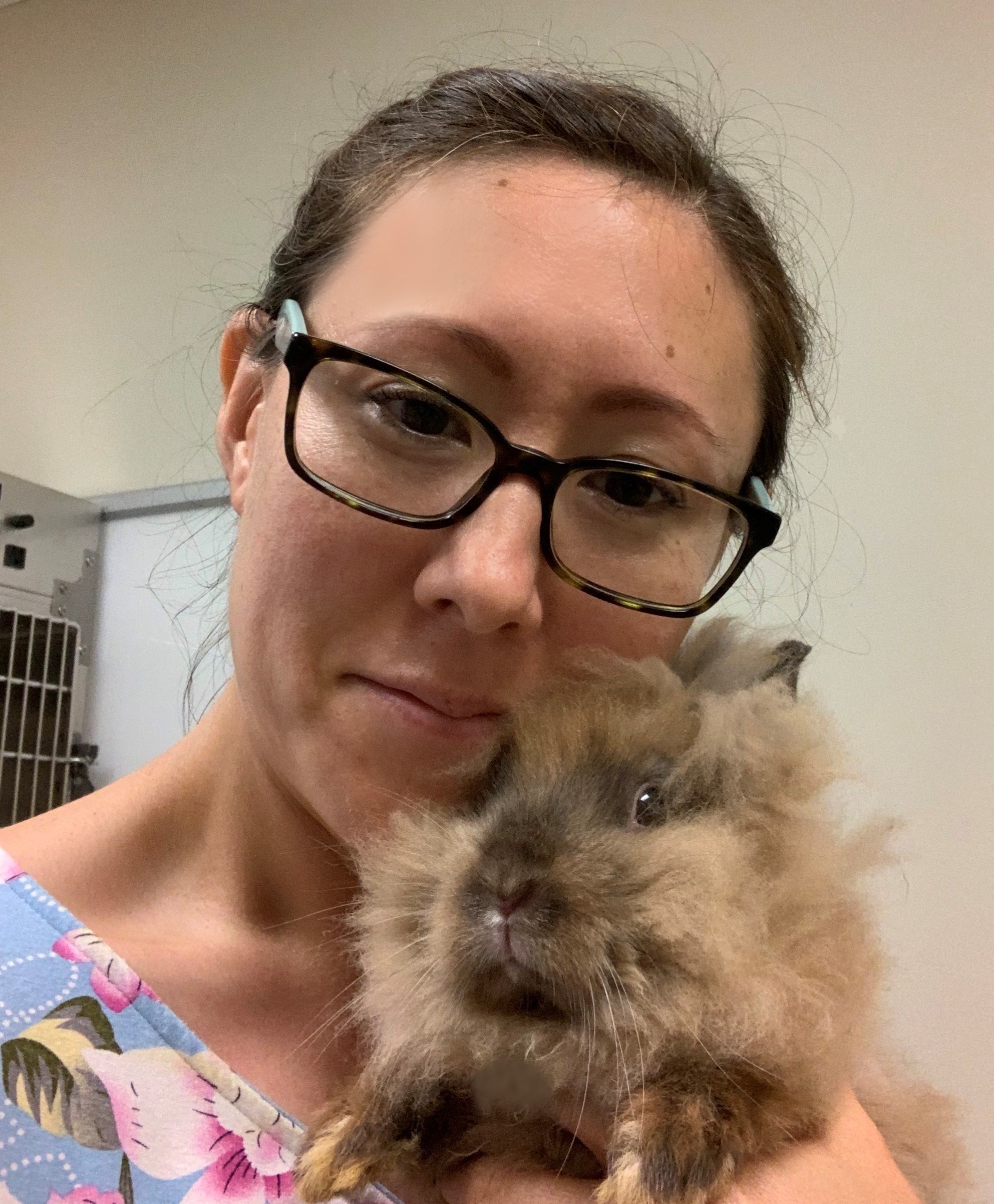Lisa snuggles a very fluffy bunny.