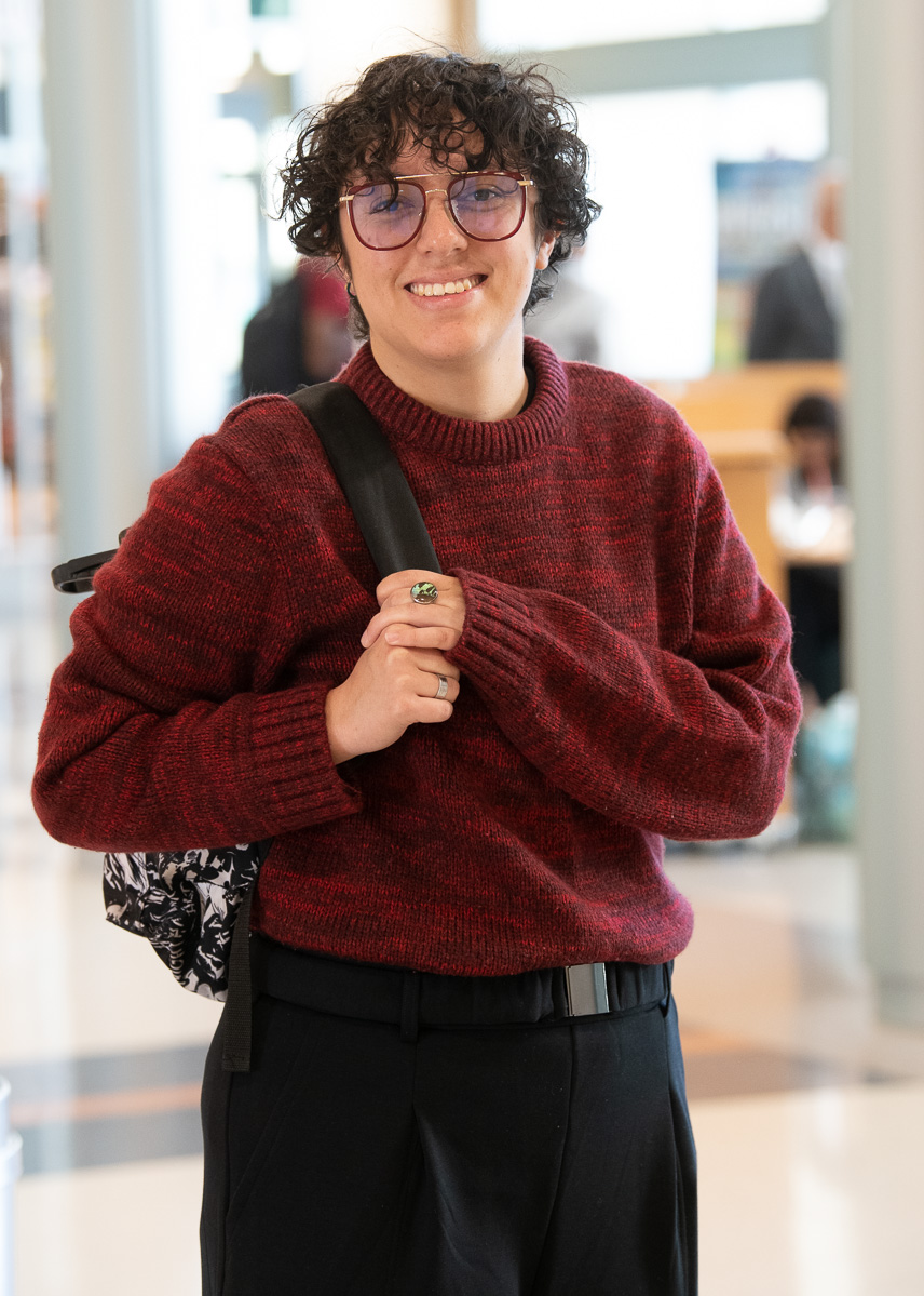 Nataly Pestena poses with her bookbag and a big smile on her face.