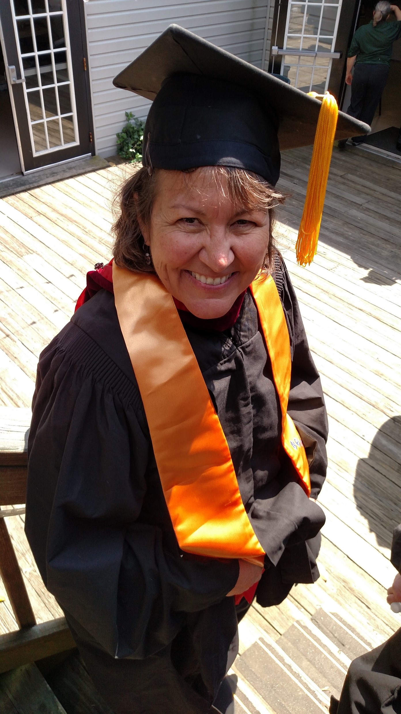 Photo of Professor Nan Peck dressed in regalia ready to celebrate Nighthawks graduation!