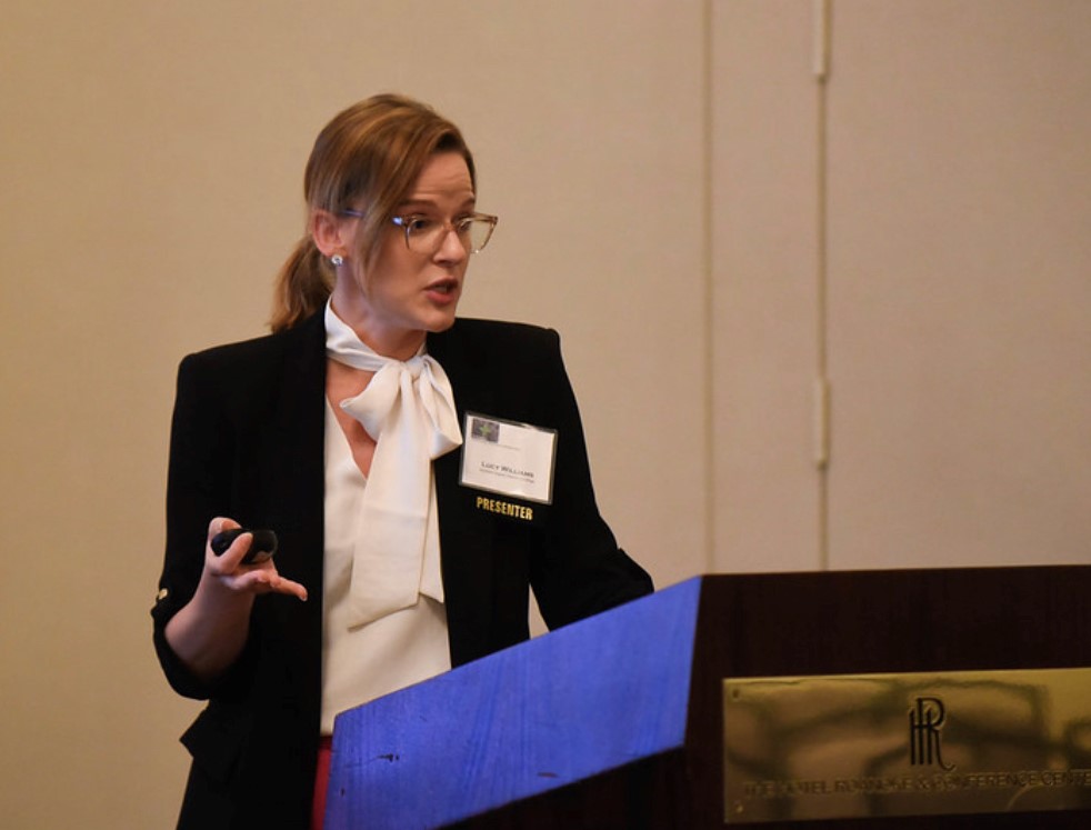 Lucy Williams stands at a podium an gives a presentation