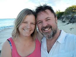Josephine Matyas and Craig Jones smile together on a beach
