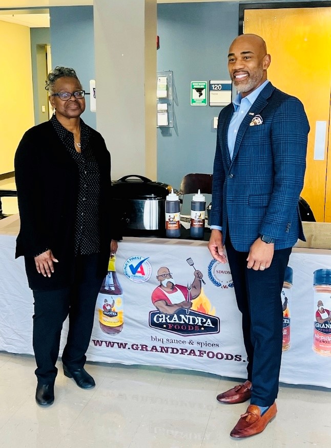 Rose Mary Bellamy poses at the Woodbridge Campus Welcome Center with Woodbridge Provost Dr. Richmond Hill