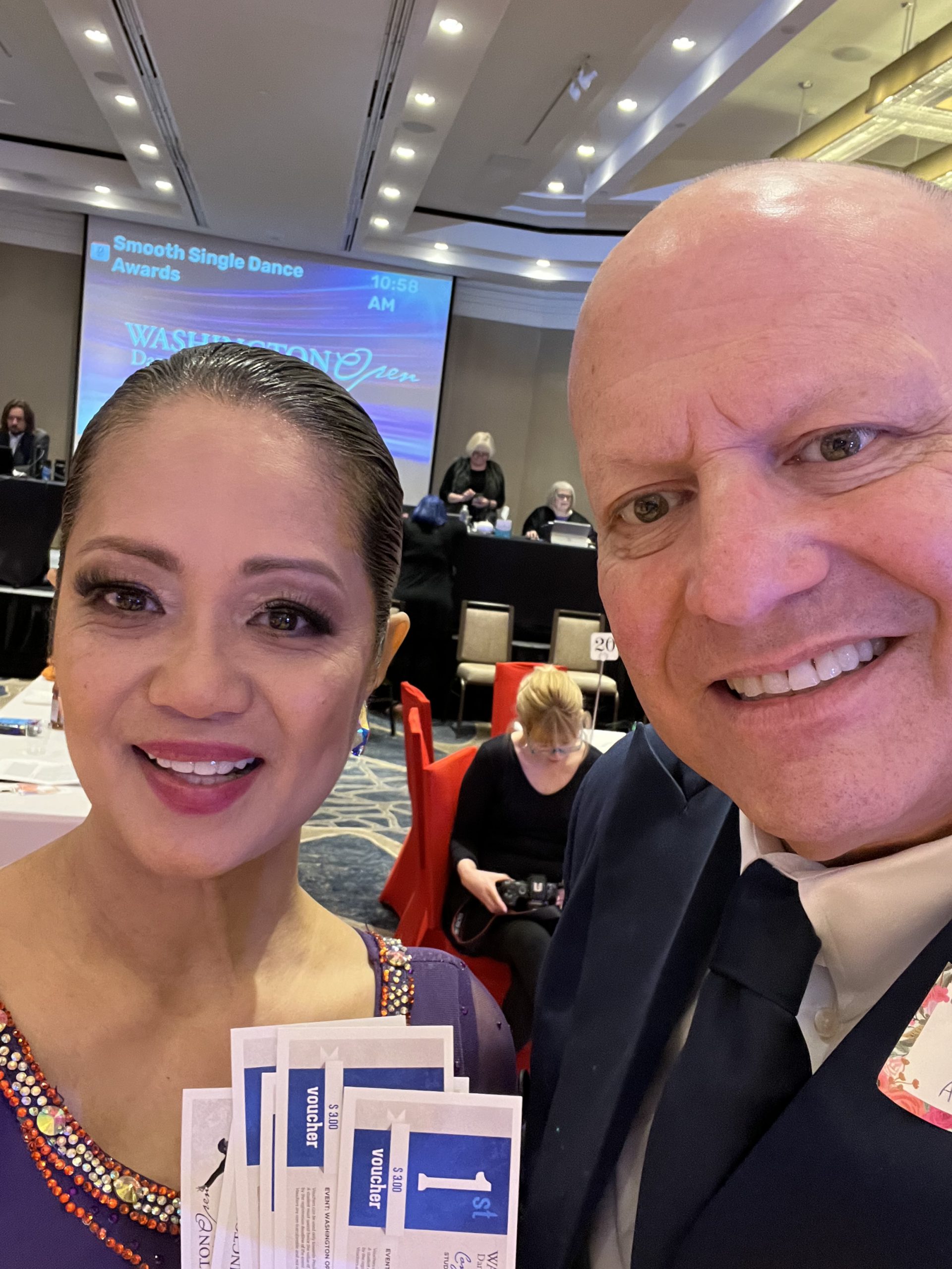 Alan Golombek and wife Thuy pose for a selfie while holding the handful of first-place awards