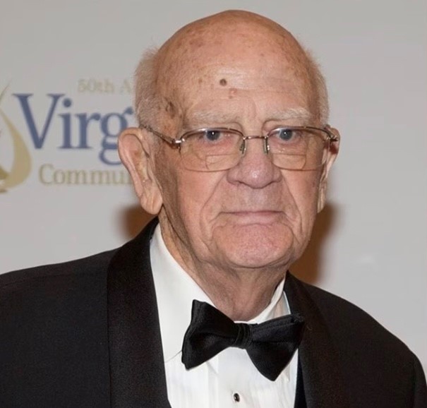 Dr. Dana B. Hamel, in a tuxedo and bow tie poses at the VCCS' 50th anniversary gala.