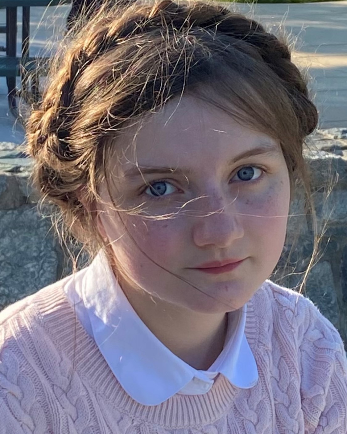 Elisabeth Bodin wearing a pint sweater and peter pan collar, with her hair styled in a european style of a braid wreath.