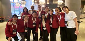 NOVA SkillsUSA students in a group shot in their hotel lobby in Atlanta after their medal wins at the 2023 National Skills and Leadership Conference. Back Row (L to R): Soham Nawthale, Jonatan Solomon Gebremichael, Nathaniel Bunger, Ardian Peach. Front Row (L to R): Takeshi Tamashiro-Pardo, Marcus Dent, Claudio Molina, Dhyuthi Chegu, Kanykei Korosheva, Mahelet Gebremichael, Nora Kaup