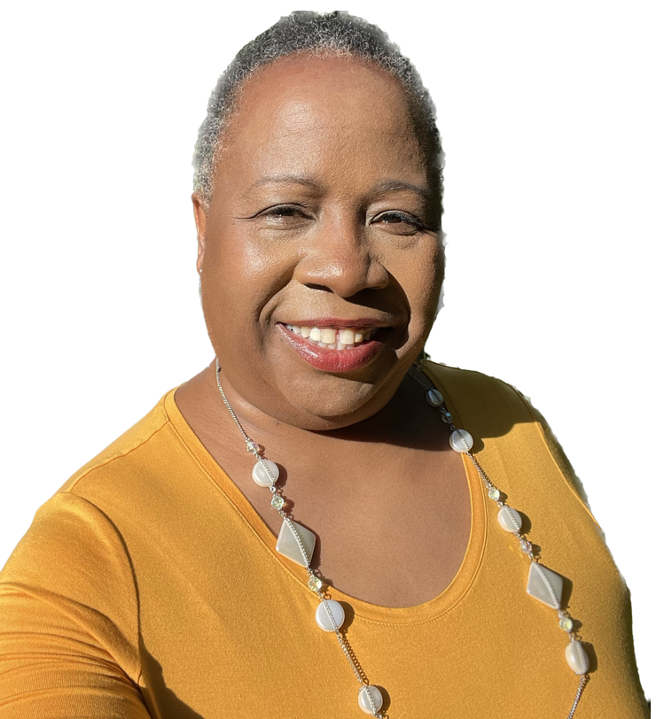 Bernice Mayfield, wearing a mustard-colored top and a necklace with off white, geometric shapes, smiles for a photo.