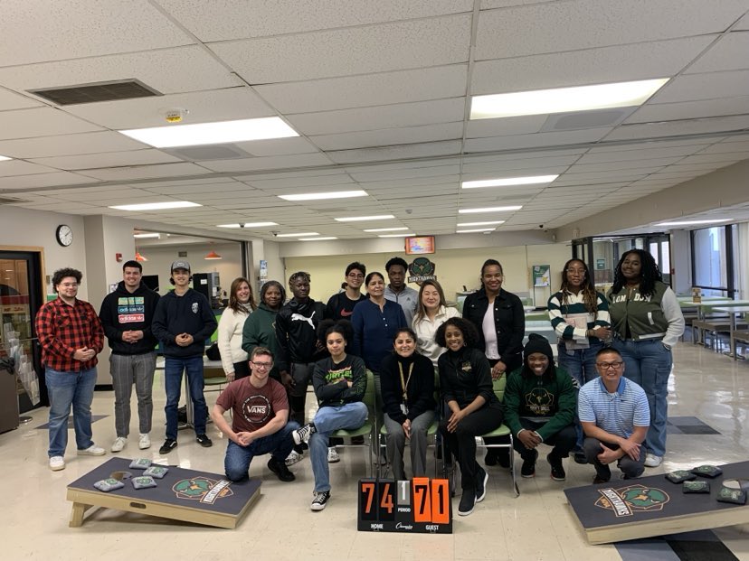 CJ Jackson poses with the teams who participated in the Manassas Campus cornhole tournament.