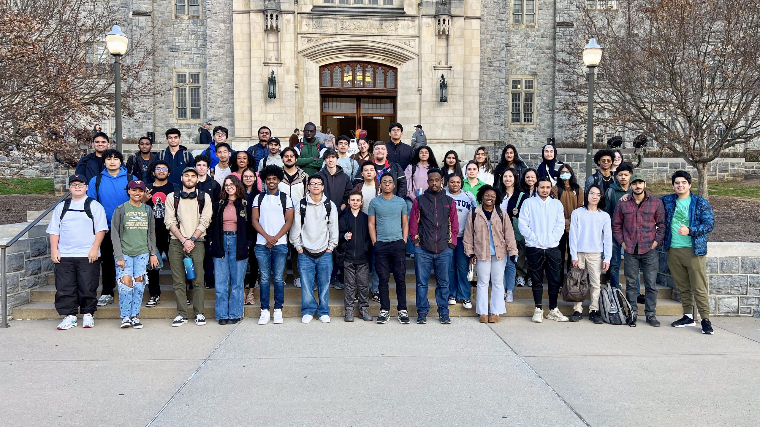 47 NOVA students from the NOVA VT Engineering Transfer Club smile for the camera outside Burruss Hall at Virginia Tech.