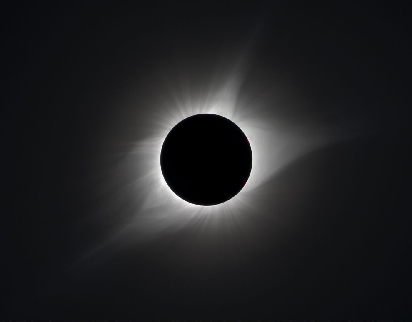 A black-and-white photograph of a total solar eclipse. 