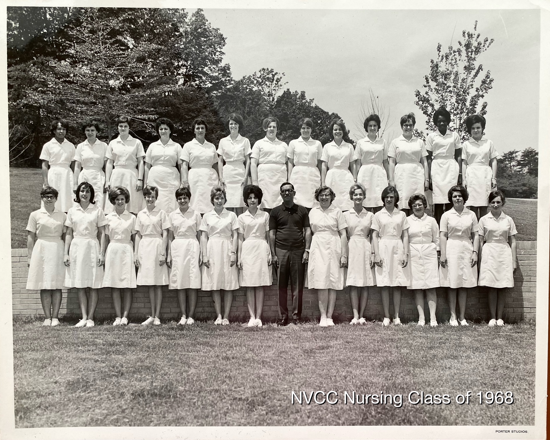 Black-and-white photograph of NOVA's inaugural nursing class of 1968. Two rows of nursing students smile for their class photo. Jane Martin is in the front row, fourth from the left.