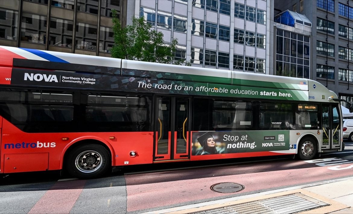 a Metrobus adorned in a bus wrap with a smiling NOVA graduate wearing commencement regalia. Text: NOVA logo, "The road to an affordable education starts here. Stop at Nothing." and a QR code to register.