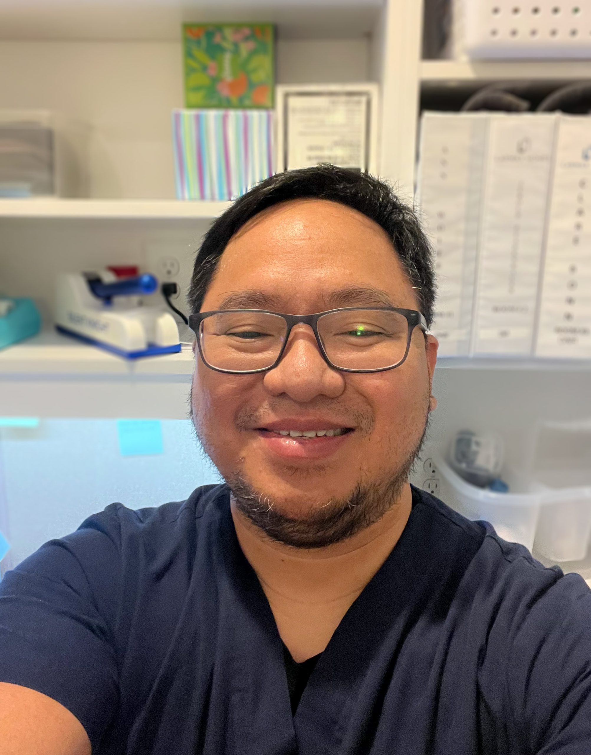 Metallica Scholar Matthew Marquez smiles for a selfie at his work station