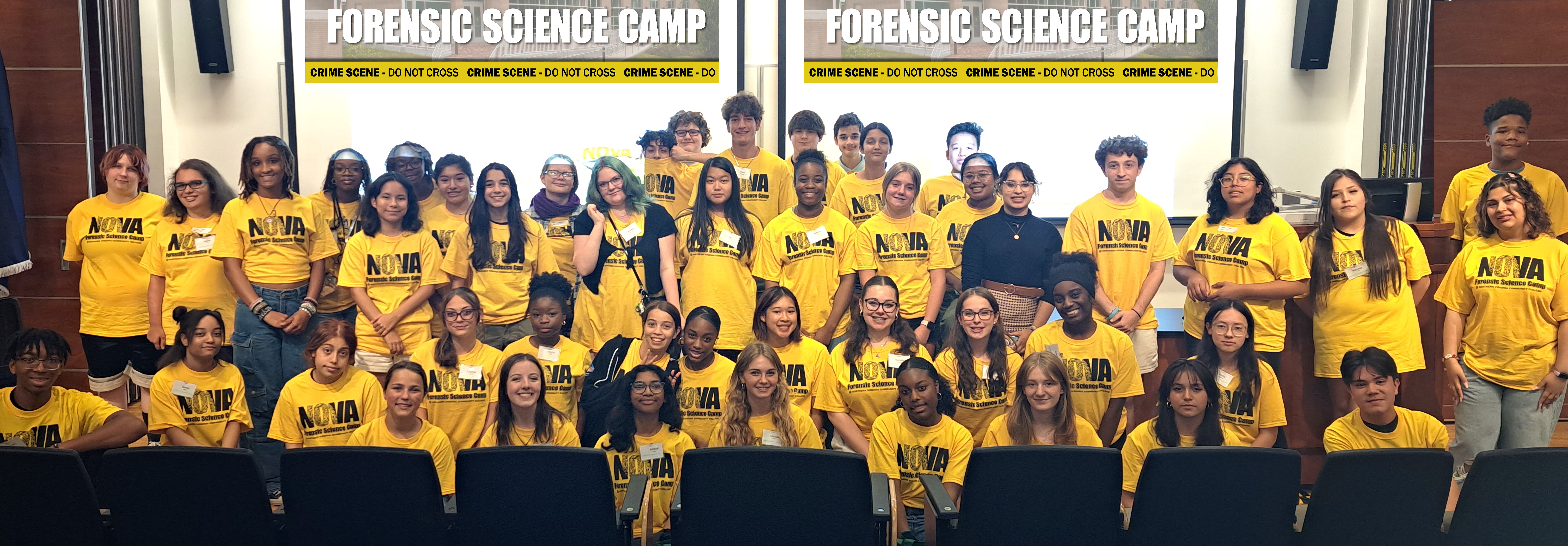 The entire group of campers, wearing their yellow camp shirts, smile for a group photo!
