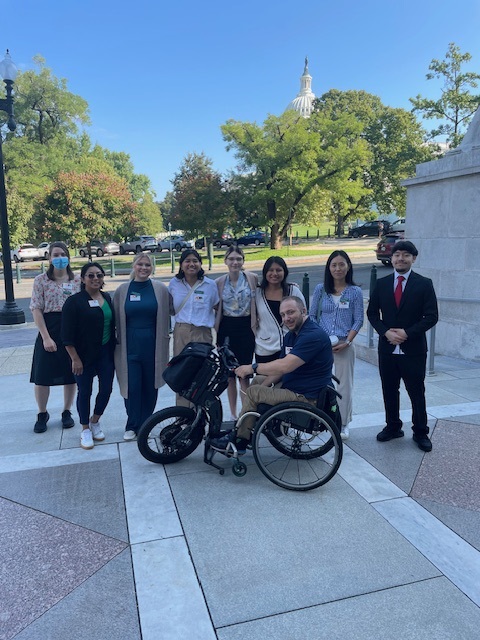 Nine OTA students gather with the capitol building in the background.