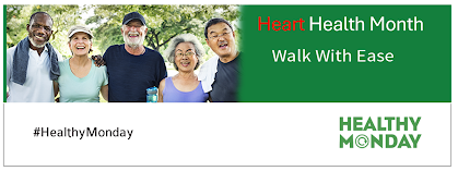 A group of five diverse older adults smiles while standing together outdoors in a park, dressed in casual athletic wear. The banner features the text "Heart Health Month – Walk With Ease" in bold letters, with "Heart" highlighted in red. Below, the hashtag "#HealthyMonday" appears, along with the "Healthy Monday" logo in green. The background is bright and natural, emphasizing an active and healthy lifestyle.