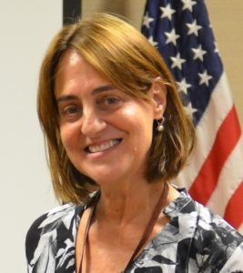 Photo of former diplomat and current NOVA instructor Susan Ross taken in front of an American Flag